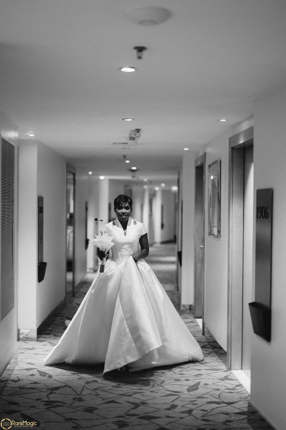 Bride walking down the hotel corridor in a full ball gown