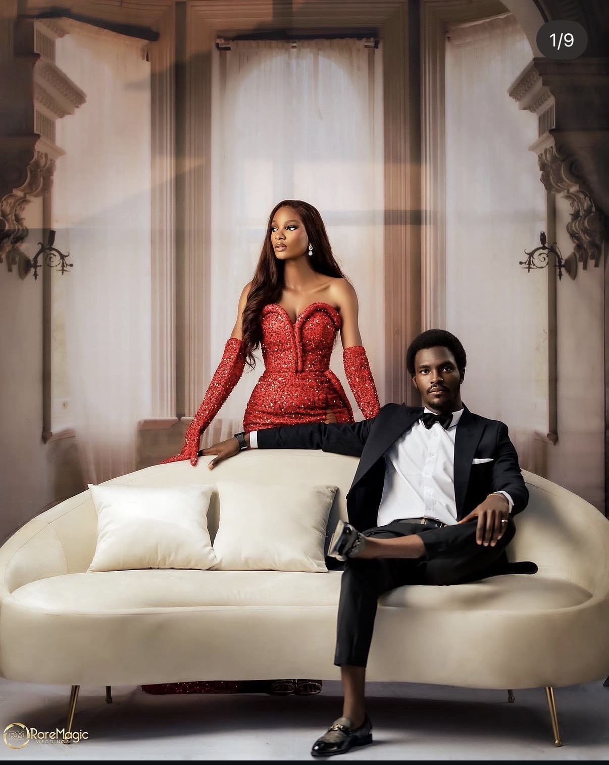 Editorial portrait of couple in red and black on a sofa