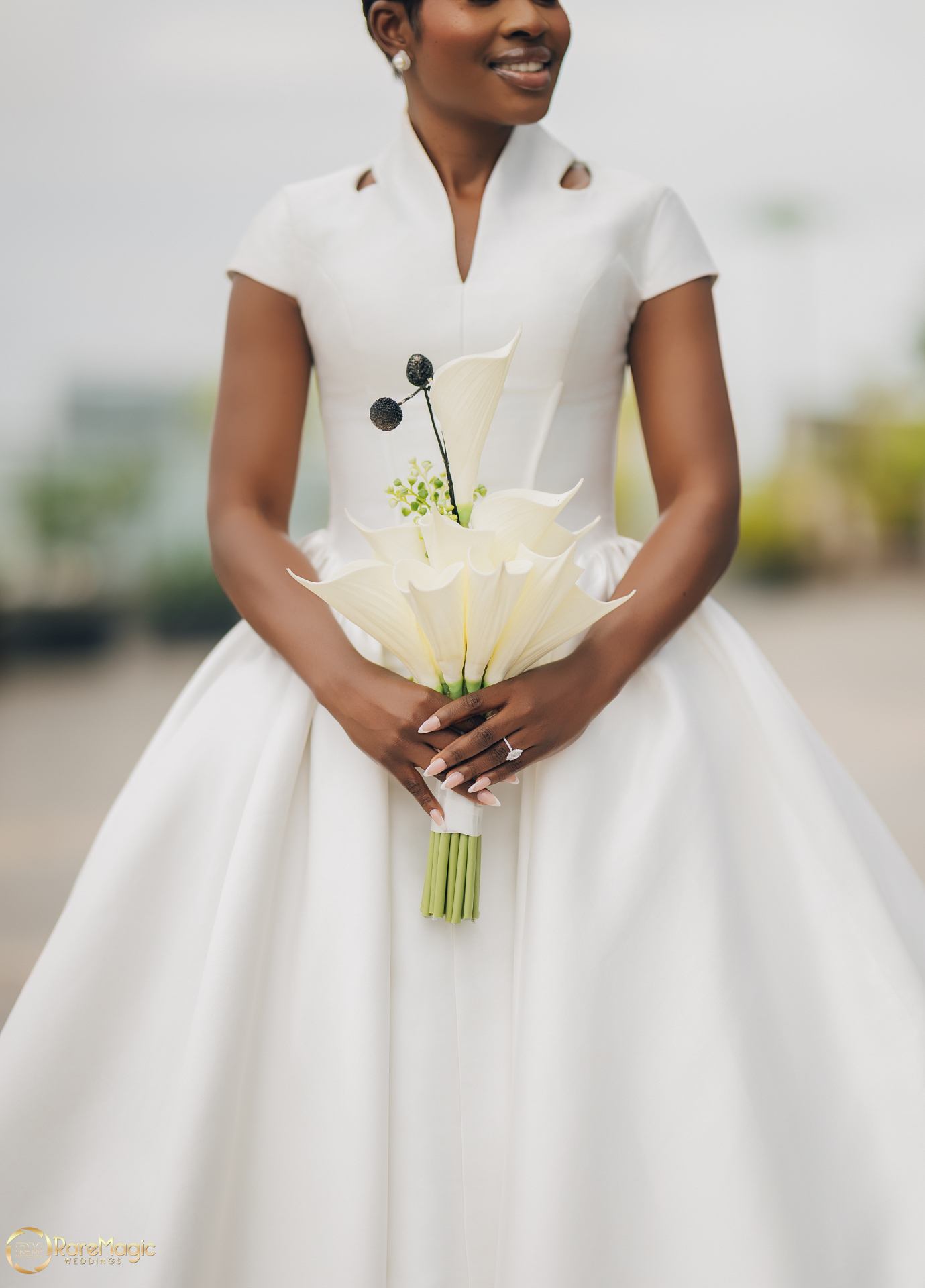 Close-up of the bride holding a white calla lily bouquet