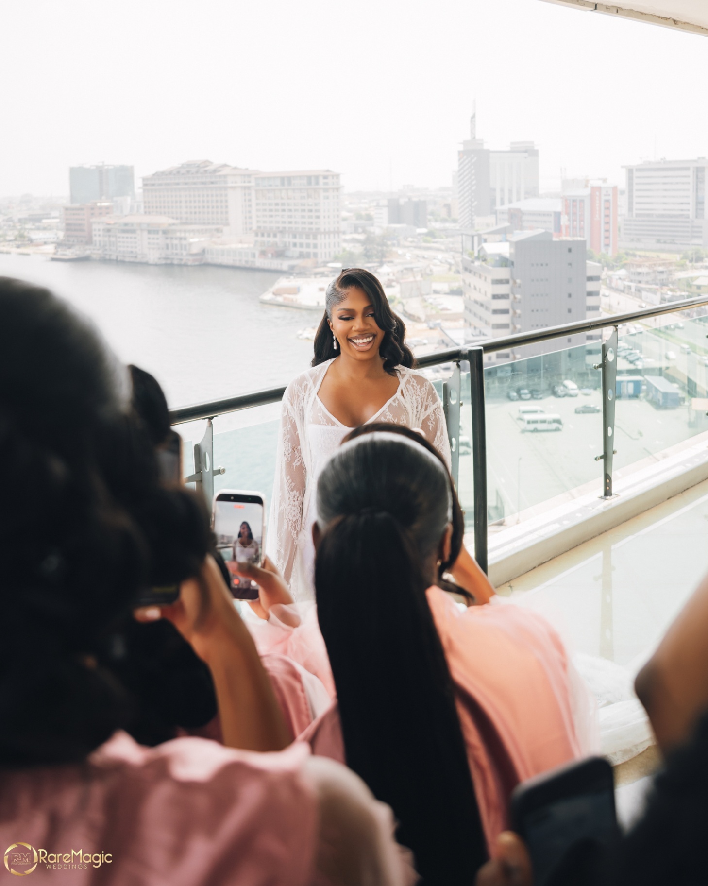 Bridesmaids photographing the bride during preparations