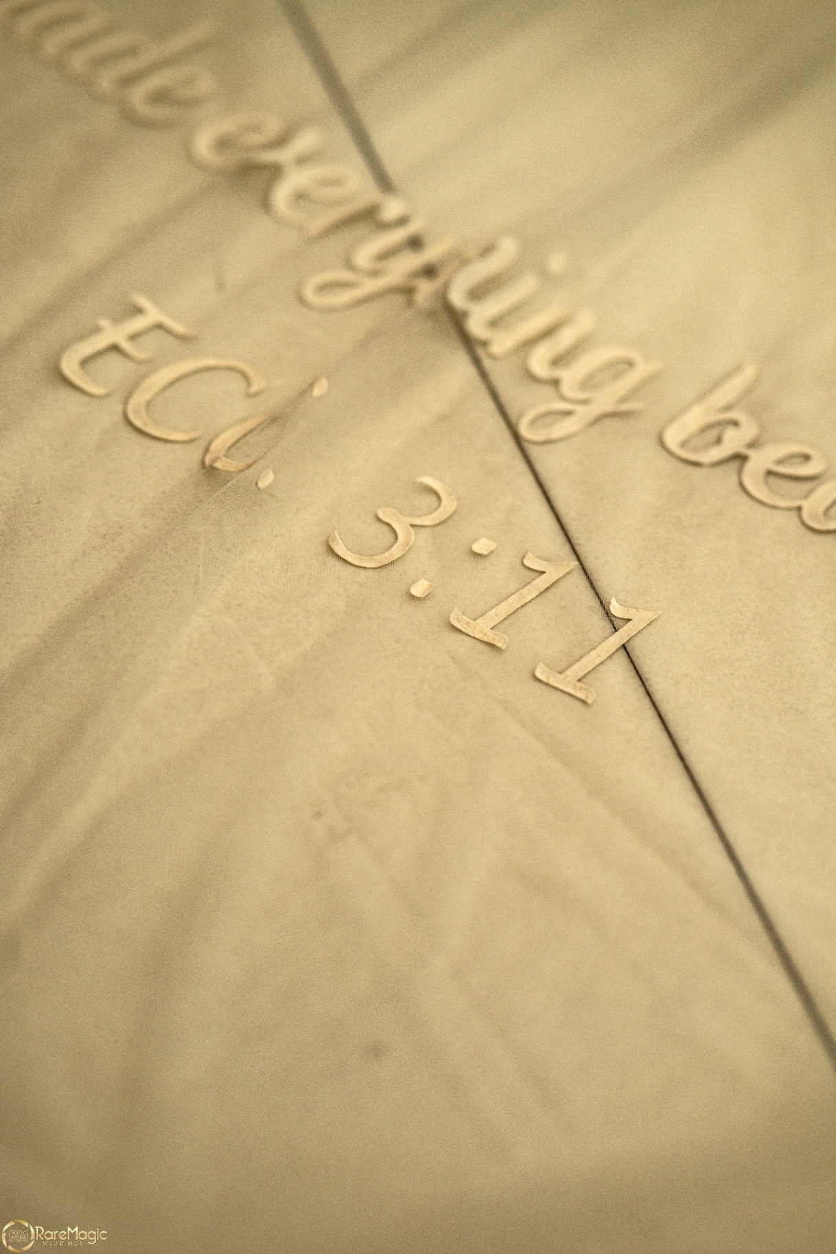 Close-up detail of the wedding invitation with the ceremony time