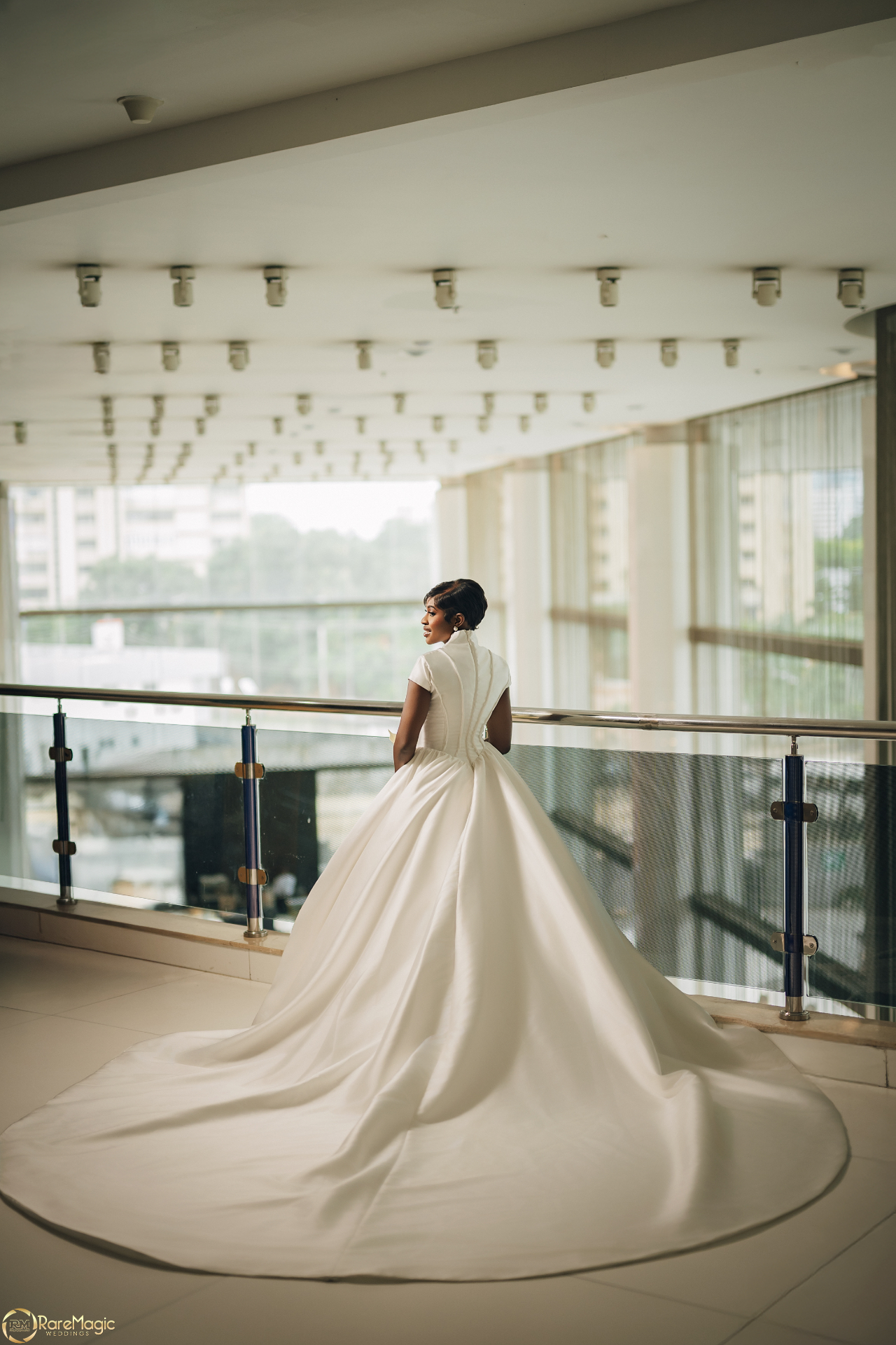 Back view of the bride in a sculptural gown with an extended train