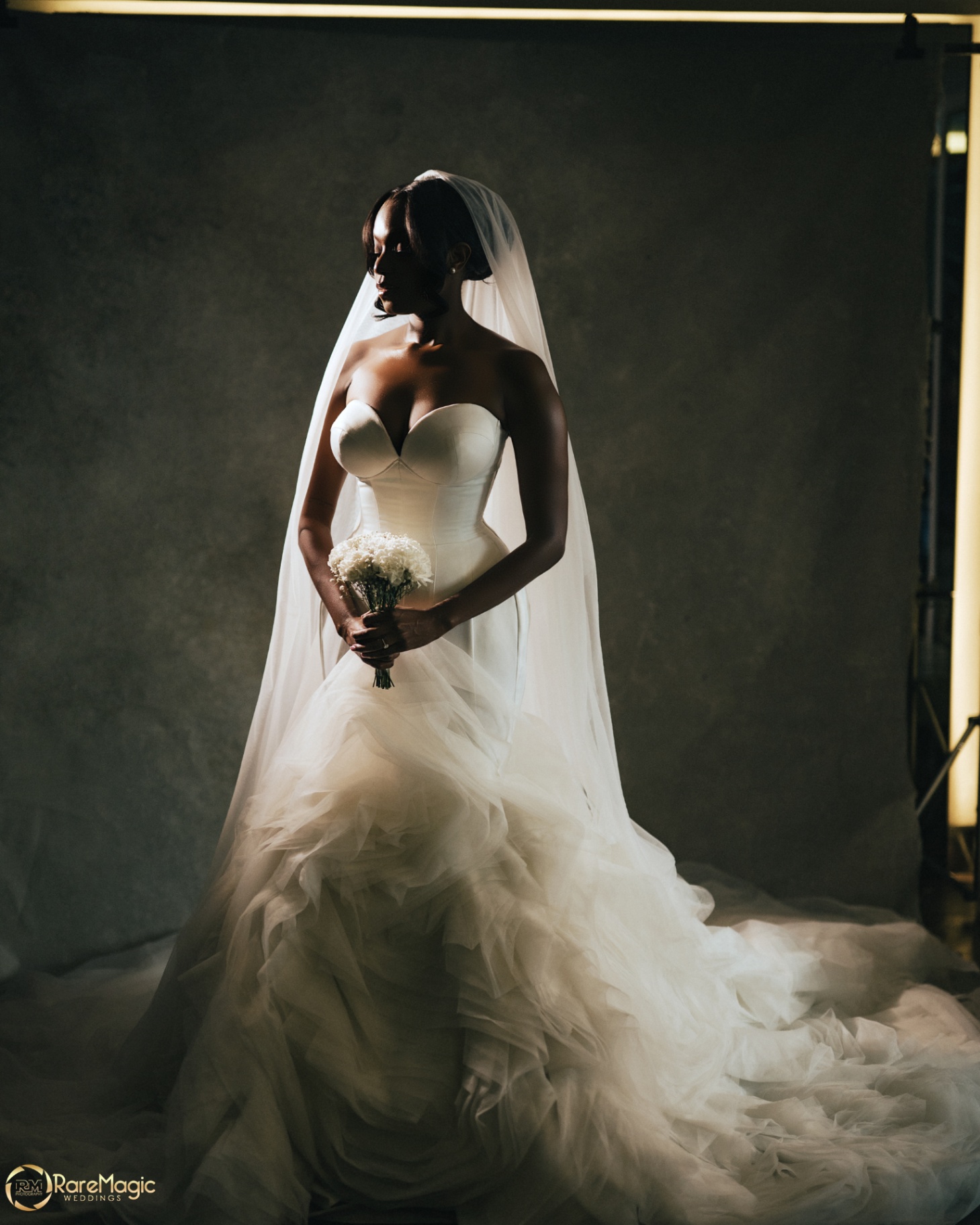 Bride in strapless gown with cathedral veil and bouquet