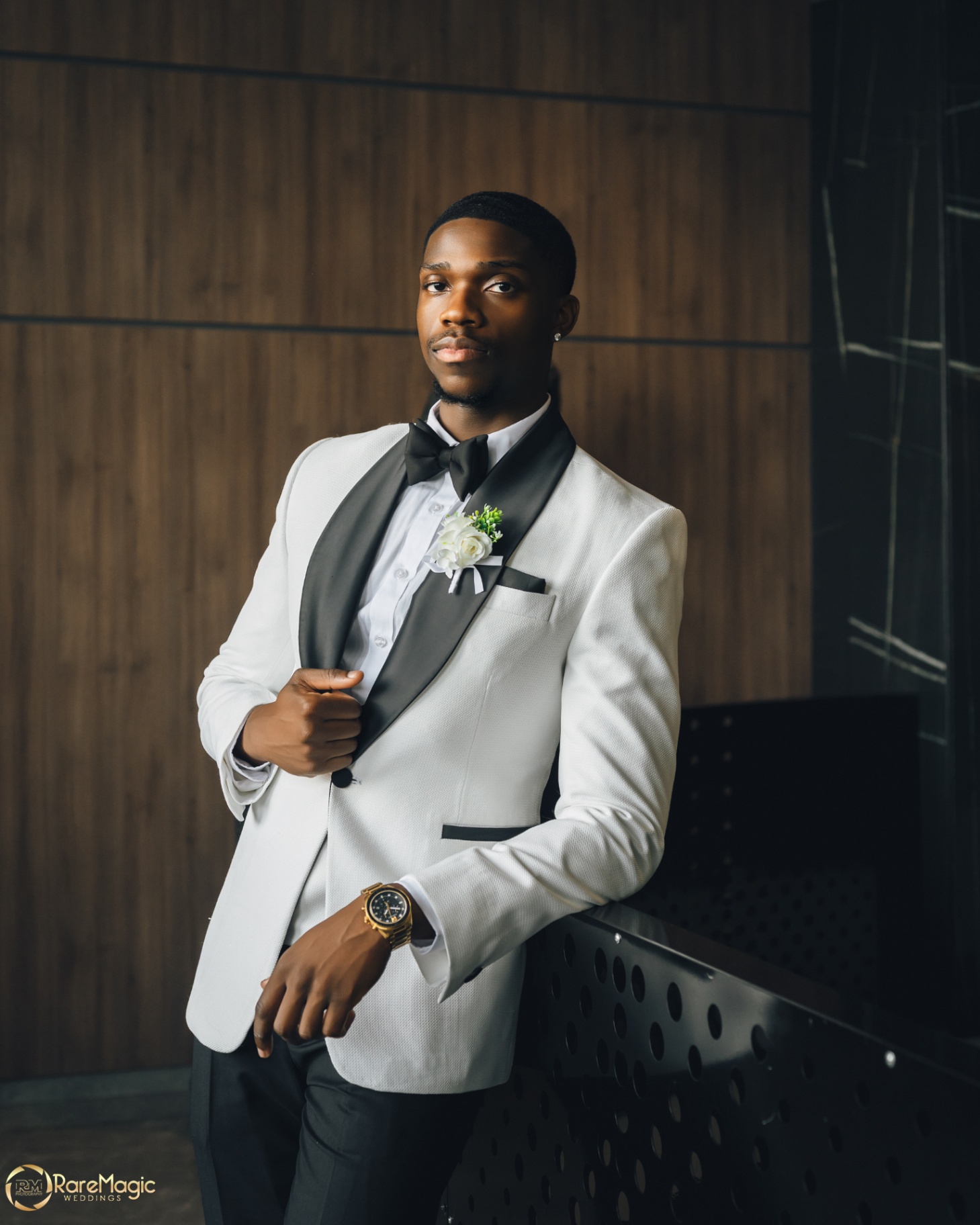 Groom portrait in a white tuxedo jacket and bow tie