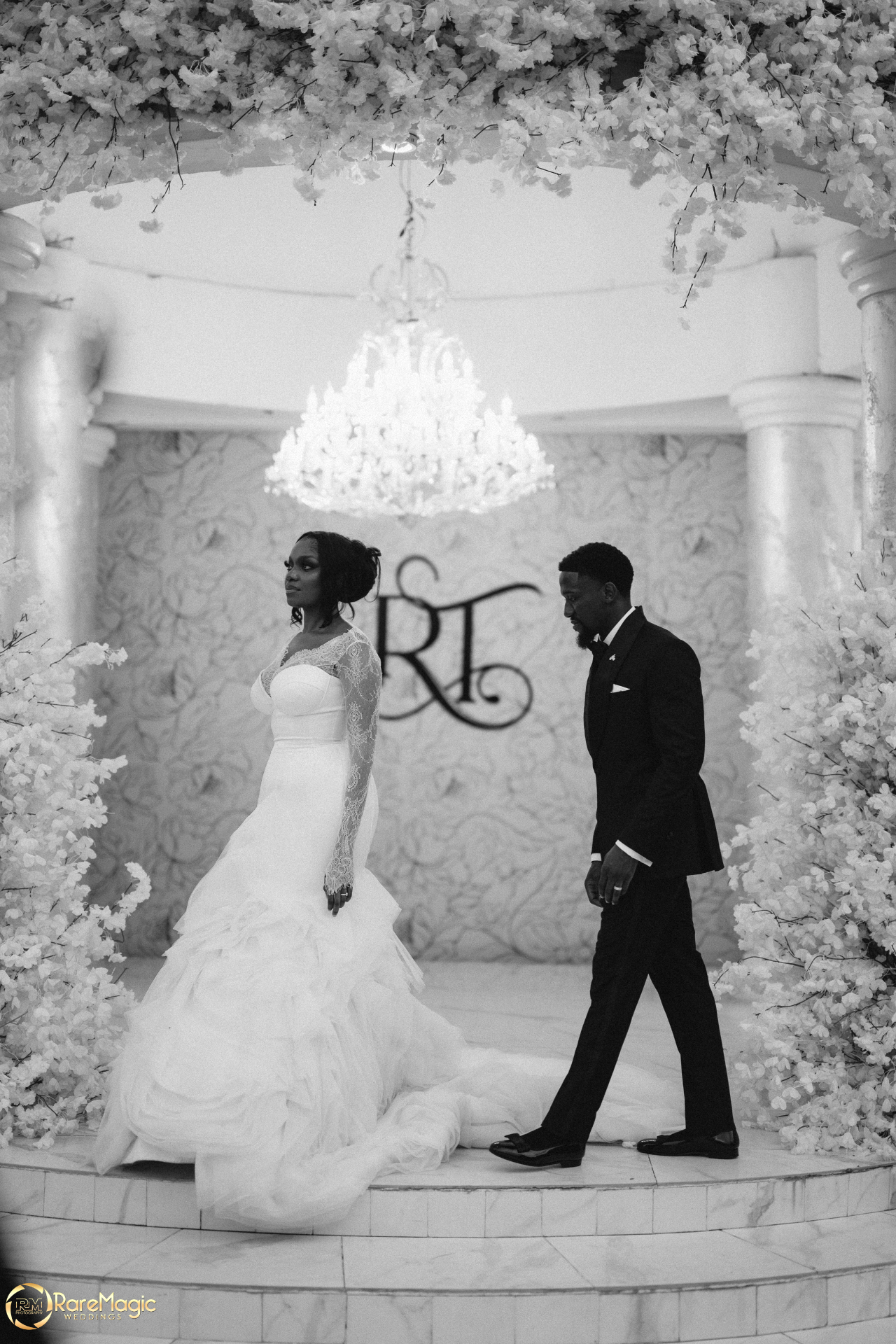 Bride and groom on a floral reception stage