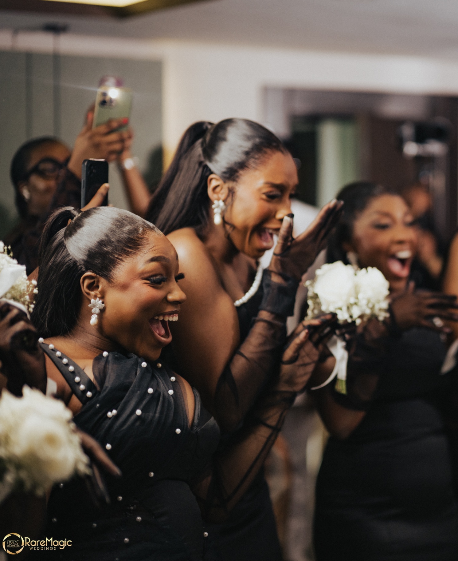 Bridesmaids cheering in black gowns