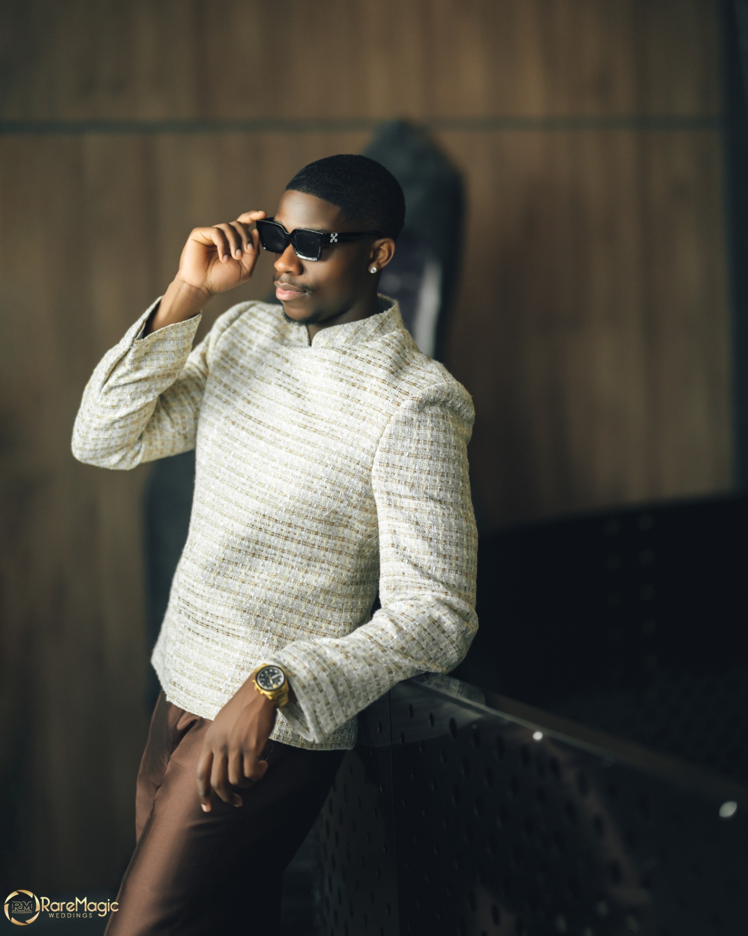 Groom portrait in textured cream attire and sunglasses
