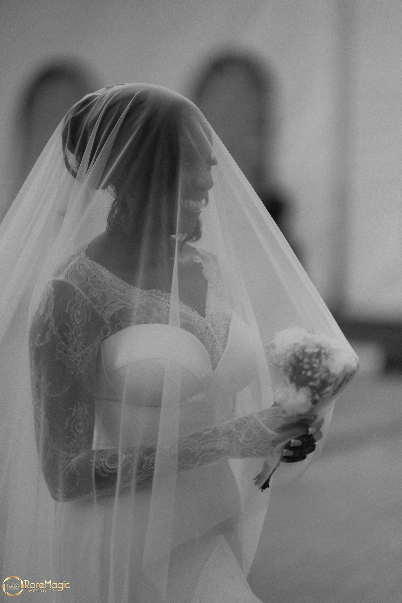 Black and white bridal portrait beneath the veil